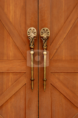 To use this stock image in your creative project, please select the size you need over to the right and click the "Add to Cart" button.
Your downloaded image will come with the Cutcaster watermark removed so don’t worry about the watermark you see on this page. Brass Door Ornament stock photo, Antique doors are accented with beatiful brass handles. by Charles Buegeler
