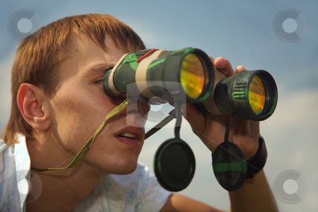 To use this stock image in your creative project, please select the size you need over to the right and click the "Add to Cart" button.
Your downloaded image will come with the Cutcaster watermark removed so don’t worry about the watermark you see on this page. Secret tracking. stock photo, The young man looks at the removed subjects through the field-glass. by Sergey Goruppa