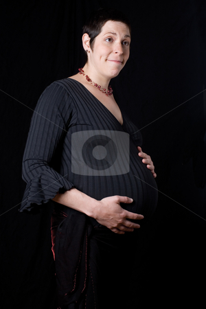 To use this stock image in your creative project, please select the size you need over to the right and click the "Add to Cart" button.
Your downloaded image will come with the Cutcaster watermark removed so don’t worry about the watermark you see on this page. Pregnant Women stock photo, Pregnant women with sparkly skirt holding her belly giving a dumb found look by Yann Poirier