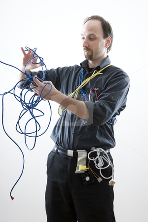 To use this stock image in your creative project, please select the size you need over to the right and click the "Add to Cart" button.
Your downloaded image will come with the Cutcaster watermark removed so don’t worry about the watermark you see on this page. Confuse technician stock photo, Computer technician looking confuse trying to untie network cable by Yann Poirier