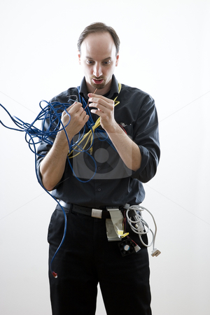 To use this stock image in your creative project, please select the size you need over to the right and click the "Add to Cart" button.
Your downloaded image will come with the Cutcaster watermark removed so don’t worry about the watermark you see on this page. Dumb technician stock photo, Dumb technician surprise by wires in his hand by Yann Poirier