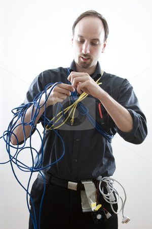 To use this stock image in your creative project, please select the size you need over to the right and click the "Add to Cart" button.
Your downloaded image will come with the Cutcaster watermark removed so don’t worry about the watermark you see on this page. Stuck in wires stock photo, Computer technician trying to figure wires by Yann Poirier