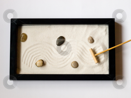 To use this stock image in your creative project, please select the size you need over to the right and click the "Add to Cart" button.
Your downloaded image will come with the Cutcaster watermark removed so don’t worry about the watermark you see on this page. Miniature Japanese zen garden stock photo, Close-up of a a miniature Japanese zen garden with a wooden rake and stones. by FEL Yannick