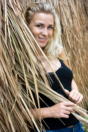 To use this stock image in your creative project, please select the size you need over to the right and click the "Add to Cart" button.
Your downloaded image will come with the Cutcaster watermark removed so don’t worry about the watermark you see on this page. Girl in straws stock photo, Beautiful blonde girl standing at straw wall by Dmitry Rostovtsev