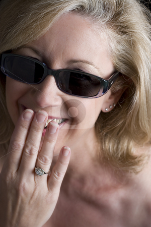 To use this stock image in your creative project, please select the size you need over to the right and click the "Add to Cart" button.
Your downloaded image will come with the Cutcaster watermark removed so don’t worry about the watermark you see on this page. Fashionyta having a shy laugh stock photo, Women in her early fifties hidding a shy laugh behind her hand by Yann Poirier