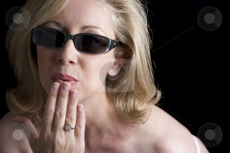 To use this stock image in your creative project, please select the size you need over to the right and click the "Add to Cart" button.
Your downloaded image will come with the Cutcaster watermark removed so don’t worry about the watermark you see on this page. Fashionyta blowing a kiss stock photo, Women in her early fifties wearing sunglass blowing a kiss. Her left thumb has a bandage due to a paper cut by Yann Poirier