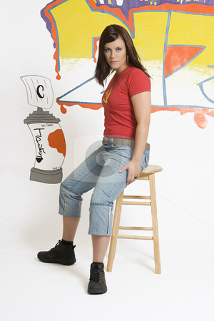 To use this stock image in your creative project, please select the size you need over to the right and click the "Add to Cart" button.
Your downloaded image will come with the Cutcaster watermark removed so don’t worry about the watermark you see on this page. Sitting on stool stock photo, Teen girl sitting on stool in front of graffitied wall by Yann Poirier