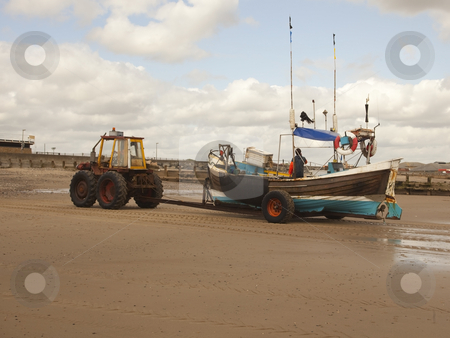To use this stock image in your creative project, please select the size you need over to the right and click the "Add to Cart" button.
Your downloaded image will come with the Cutcaster watermark removed so don’t worry about the watermark you see on this page. Tractor towing fishing boat stock photo, A tractor towing a fishing boat home on a beach in summer by Mike Smith