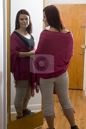 To use this stock image in your creative project, please select the size you need over to the right and click the "Add to Cart" button.
Your downloaded image will come with the Cutcaster watermark removed so don’t worry about the watermark you see on this page. Women in front of mirror stock photo, Young woman standing in front of mirror adjusting shawl by Yann Poirier