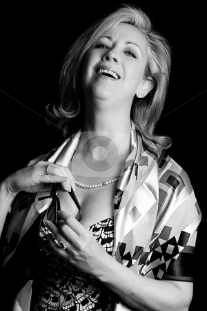 To use this stock image in your creative project, please select the size you need over to the right and click the "Add to Cart" button.
Your downloaded image will come with the Cutcaster watermark removed so don’t worry about the watermark you see on this page. Women in her early fifties stock photo, Women in her early fifties with classic Audrey Hepburn putting her glass away, in probably the sexiest way possible and have a great laugh about it by Yann Poirier