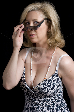 To use this stock image in your creative project, please select the size you need over to the right and click the "Add to Cart" button.
Your downloaded image will come with the Cutcaster watermark removed so don’t worry about the watermark you see on this page. Fashionyta removing sunglasses stock photo, Women in her early fifties taking off her sunglasses by Yann Poirier