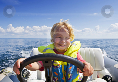 To use this stock image in your creative project, please select the size you need over to the right and click the "Add to Cart" button.
Your downloaded image will come with the Cutcaster watermark removed so don’t worry about the watermark you see on this page. Young helmsman stock photo, Young boy behind the steering wheel of an inflatable speedboat by Corepics VOF