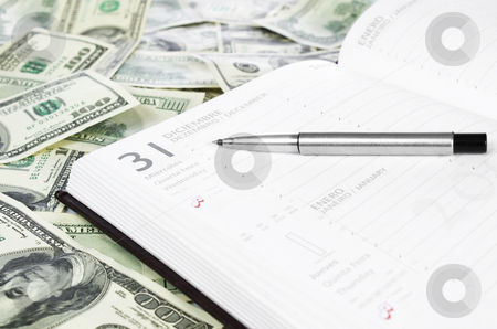 To use this stock image in your creative project, please select the size you need over to the right and click the "Add to Cart" button.
Your downloaded image will come with the Cutcaster watermark removed so don’t worry about the watermark you see on this page. Open notebook stock photo, A notebook open on december thirty first over a lot of dollar bills. by Ignacio Gonzalez Prado