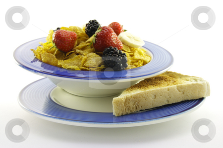 To use this stock image in your creative project, please select the size you need over to the right and click the "Add to Cart" button.
Your downloaded image will come with the Cutcaster watermark removed so don’t worry about the watermark you see on this page. Cornflakes and Fruit with Toast stock photo, Cornflakes with strawberries, blackberries and banana in a round blue bowl with a slice of toast on a plate with a white background by Keith Wilson
