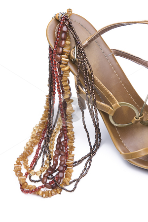 To use this stock image in your creative project, please select the size you need over to the right and click the "Add to Cart" button.
Your downloaded image will come with the Cutcaster watermark removed so don’t worry about the watermark you see on this page. Shoe and jewelery stock photo, Brown high heels with necklace by Yann Poirier