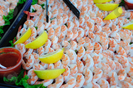 To use this stock image in your creative project, please select the size you need over to the right and click the "Add to Cart" button.
Your downloaded image will come with the Cutcaster watermark removed so don’t worry about the watermark you see on this page. Cooked Shrimp And Lemon Wedges stock photo, A large tray of shelled and cooked shrimp with lemon slices and seafood sauce. by Lynn Bendickson