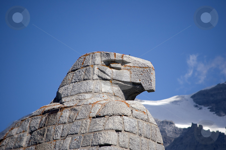 To use this stock image in your creative project, please select the size you need over to the right and click the "Add to Cart" button.
Your downloaded image will come with the Cutcaster watermark removed so don’t worry about the watermark you see on this page. Eagle statue stock photo, A statue of an eagle, head details, mountains in background by Roberto Marinello