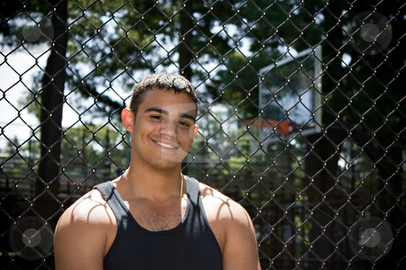 To use this stock image in your creative project, please select the size you need over to the right and click the "Add to Cart" button.
Your downloaded image will come with the Cutcaster watermark removed so don’t worry about the watermark you see on this page. Smiling Basketball Player stock photo, A smiling young man posing outside the basketball court. by Todd Arena
