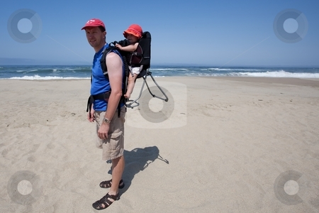 To use this stock image in your creative project, please select the size you need over to the right and click the "Add to Cart" button.
Your downloaded image will come with the Cutcaster watermark removed so don’t worry about the watermark you see on this page. Child carrier on the beach stock photo, Child carrier is a device used to carry an infant or small child on the body of an adult. by Mariusz Jurgielewicz