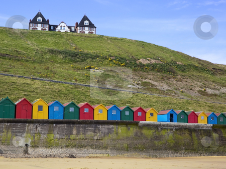 To use this stock image in your creative project, please select the size you need over to the right and click the "Add to Cart" button.
Your downloaded image will come with the Cutcaster watermark removed so don’t worry about the watermark you see on this page. Beach huts and house stock photo, Colourful beach huts at the coast with a house on a hill by Mike Smith