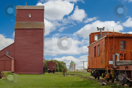 To use this stock image in your creative project, please select the size you need over to the right and click the "Add to Cart" button.
Your downloaded image will come with the Cutcaster watermark removed so don’t worry about the watermark you see on this page. Grain Elevator With Train stock photo, A grain elevator looming in the distance with a rear of a train sitting close by by Richard Nelson