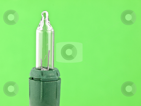 To use this stock image in your creative project, please select the size you need over to the right and click the "Add to Cart" button.
Your downloaded image will come with the Cutcaster watermark removed so don’t worry about the watermark you see on this page. Christmas Light stock photo, Christmas light bulb on a green background by John Teeter
