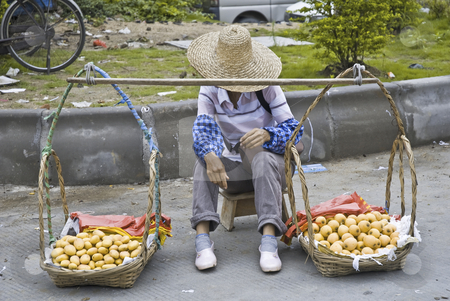 To use this stock image in your creative project, please select the size you need over to the right and click the "Add to Cart" button.
Your downloaded image will come with the Cutcaster watermark removed so don’t worry about the watermark you see on this page. Fruit Sales Woman stock photo, Selling on the street woman in China waiting for customers by Marek Poplawski