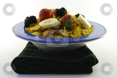 To use this stock image in your creative project, please select the size you need over to the right and click the "Add to Cart" button.
Your downloaded image will come with the Cutcaster watermark removed so don’t worry about the watermark you see on this page. Cornflakes and Fruit in a Bowl with Napkin stock photo, Cornflakes with strawberries, blackberries and banana in a round blue bowl with a black napkin on a white background by Keith Wilson