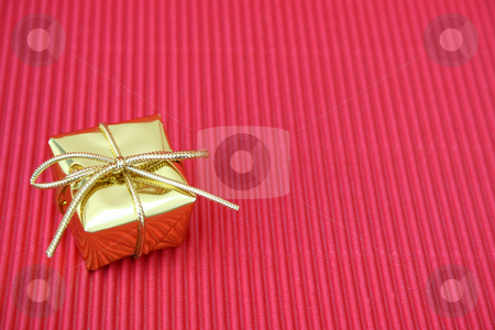 To use this stock image in your creative project, please select the size you need over to the right and click the "Add to Cart" button.
Your downloaded image will come with the Cutcaster watermark removed so don’t worry about the watermark you see on this page. Christmas Gift stock photo, Small golden christmas gift on a red background by Vanessa Van Rensburg