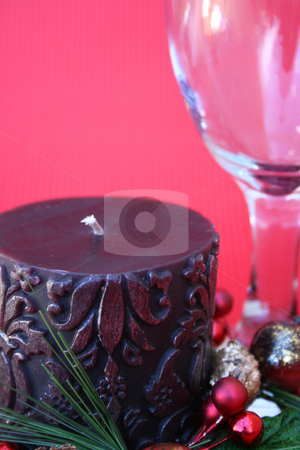 To use this stock image in your creative project, please select the size you need over to the right and click the "Add to Cart" button.
Your downloaded image will come with the Cutcaster watermark removed so don’t worry about the watermark you see on this page. Christmas Candle stock photo, Dark candle with a christmas wreath and a wine glass on a red background by Vanessa Van Rensburg
