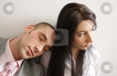 To use this stock image in your creative project, please select the size you need over to the right and click the "Add to Cart" button.
Your downloaded image will come with the Cutcaster watermark removed so don’t worry about the watermark you see on this page. Overtime stock photo, Young man and woman leaning against the wall; man is sleeping on woman's shoulder by Mikhail Lavrenov
