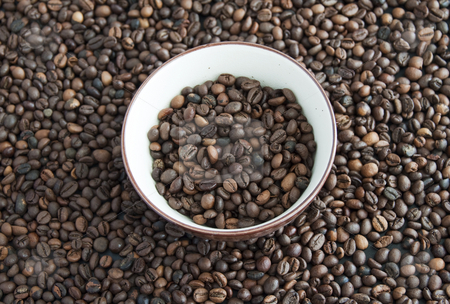 To use this stock image in your creative project, please select the size you need over to the right and click the "Add to Cart" button.
Your downloaded image will come with the Cutcaster watermark removed so don’t worry about the watermark you see on this page. Coffee stock photo, A cup full of coffee beans, surrounded by other coffee beans by Fabio Alcini