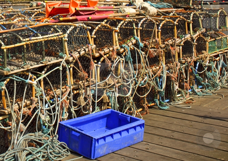 To use this stock image in your creative project, please select the size you need over to the right and click the "Add to Cart" button.
Your downloaded image will come with the Cutcaster watermark removed so don’t worry about the watermark you see on this page. Lobster pots stock photo, A selection of lobster pots on a harbour in summer by Mike Smith