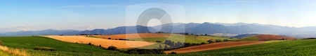 To use this stock image in your creative project, please select the size you need over to the right and click the "Add to Cart" button.
Your downloaded image will come with the Cutcaster watermark removed so don’t worry about the watermark you see on this page. Panorama of meadows and fields in evening stock photo, Big resolution panorama of summer meadows and fields by Juraj Kovacik
