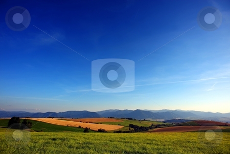 To use this stock image in your creative project, please select the size you need over to the right and click the "Add to Cart" button.
Your downloaded image will come with the Cutcaster watermark removed so don’t worry about the watermark you see on this page. Country evening summary stock photo, Country summer scenery with fields, meadows and big blue sky by Juraj Kovacik