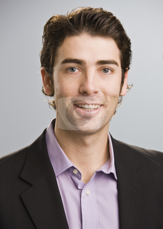 To use this stock image in your creative project, please select the size you need over to the right and click the "Add to Cart" button.
Your downloaded image will come with the Cutcaster watermark removed so don’t worry about the watermark you see on this page. Man Smiling at Camera stock photo, A young businessman is standing in a room and smiling at the camera. Vertically framed shot. by Jonathan Ross
