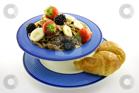 To use this stock image in your creative project, please select the size you need over to the right and click the "Add to Cart" button.
Your downloaded image will come with the Cutcaster watermark removed so don’t worry about the watermark you see on this page. Bran Flakes in a Blue Bowl stock photo, Crunchy looking delicious bran flakes and juicy fruit in a blue bowl with a croissant on a white background by Keith Wilson