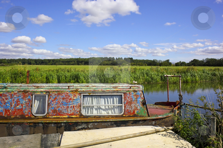To use this stock image in your creative project, please select the size you need over to the right and click the "Add to Cart" button.
Your downloaded image will come with the Cutcaster watermark removed so don’t worry about the watermark you see on this page. Summer on the river stock photo, A weathered narrow boat on a river on a beautiful summers day by Mike Smith