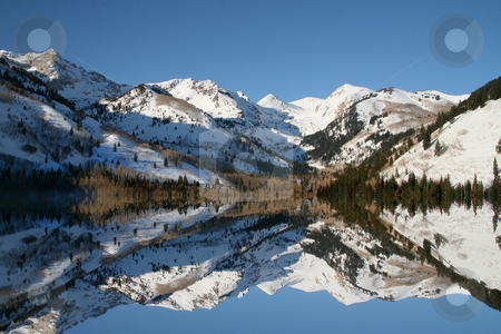 To use this stock image in your creative project, please select the size you need over to the right and click the "Add to Cart" button.
Your downloaded image will come with the Cutcaster watermark removed so don’t worry about the watermark you see on this page. WInter Reflections stock photo, Mountain Lake inf the winter showing reflections by Mark Smith