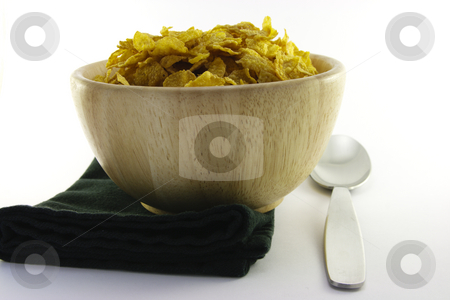 To use this stock image in your creative project, please select the size you need over to the right and click the "Add to Cart" button.
Your downloaded image will come with the Cutcaster watermark removed so don’t worry about the watermark you see on this page. Cornflakes in a Wooden Bowl with Spoon stock photo, Golden crisp cornflakes in a round wooden bowl with a black napkin and a spoon on a white background by Keith Wilson