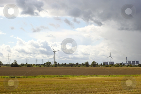 To use this stock image in your creative project, please select the size you need over to the right and click the "Add to Cart" button.
Your downloaded image will come with the Cutcaster watermark removed so don’t worry about the watermark you see on this page. Power generation stock photo, Wind turbines next to a coal fired power station under a stormy sky by Mike Smith