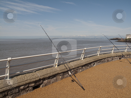 To use this stock image in your creative project, please select the size you need over to the right and click the "Add to Cart" button.
Your downloaded image will come with the Cutcaster watermark removed so don’t worry about the watermark you see on this page. FishingRodsonPier stock photo, Some Fishing Rods at the end of a Pier in Weston Super Mare by Stephen Clarke