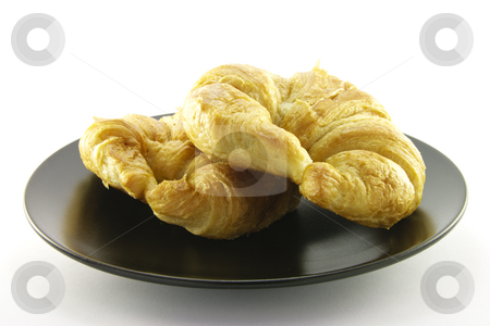To use this stock image in your creative project, please select the size you need over to the right and click the "Add to Cart" button.
Your downloaded image will come with the Cutcaster watermark removed so don’t worry about the watermark you see on this page. Two Croissants on a Black Plate stock photo, Two golden flakey delicious baked croissant on a black plate with a white background by Keith Wilson