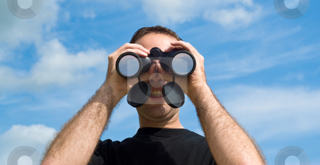 To use this stock image in your creative project, please select the size you need over to the right and click the "Add to Cart" button.
Your downloaded image will come with the Cutcaster watermark removed so don’t worry about the watermark you see on this page. Man Using Binoculars Outside stock photo, A young man looking at the viewer with a set of binoculars, with a blue sky behind him by Richard Nelson