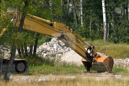 To use this stock image in your creative project, please select the size you need over to the right and click the "Add to Cart" button.
Your downloaded image will come with the Cutcaster watermark removed so don’t worry about the watermark you see on this page. Excavator Shovel stock photo, An excavator shovel with a pile of stones behind by Richard Nelson