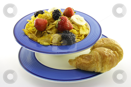 To use this stock image in your creative project, please select the size you need over to the right and click the "Add to Cart" button.
Your downloaded image will come with the Cutcaster watermark removed so don’t worry about the watermark you see on this page. Cornflakes and Fruit with Croissant stock photo, Cornflakes with strawberries, blackberries and banana in a round blue bowl with a croissant on a plate with a white background by Keith Wilson