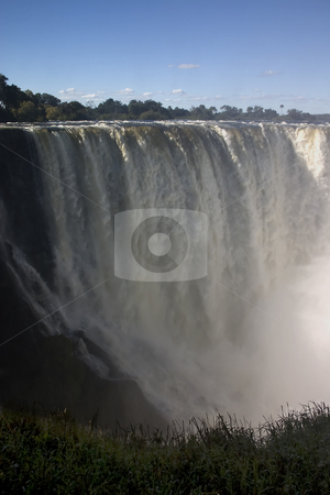 To use this stock image in your creative project, please select the size you need over to the right and click the "Add to Cart" button.
Your downloaded image will come with the Cutcaster watermark removed so don’t worry about the watermark you see on this page. The long drop stock photo, A photo of the falls with the longest drop at victoria falls, zambia, zimbabwe by Darren Pattterson