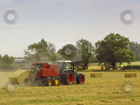 To use this stock image in your creative project, please select the size you need over to the right and click the "Add to Cart" button.
Your downloaded image will come with the Cutcaster watermark removed so don’t worry about the watermark you see on this page. Bailing straw stock photo, A tractor baling straw in summer by Mike Smith