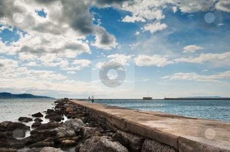 To use this stock image in your creative project, please select the size you need over to the right and click the "Add to Cart" button.
Your downloaded image will come with the Cutcaster watermark removed so don’t worry about the watermark you see on this page. Romantic walk on the pier stock photo, A couple in the distance strolling along the pier in Kalamata, southern Greece, under a spectacular cloudscape by Andreas Karelias