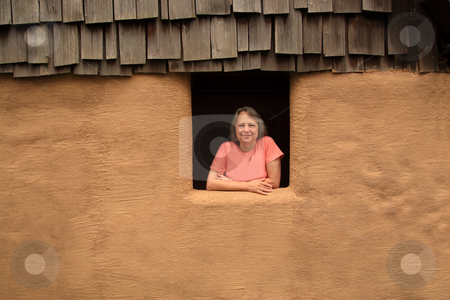 To use this stock image in your creative project, please select the size you need over to the right and click the "Add to Cart" button.
Your downloaded image will come with the Cutcaster watermark removed so don’t worry about the watermark you see on this page. Woman In The Window stock photo, Middle-aged woman leaning out of an adobe hut window into the sunlight. by Jack Schiffer